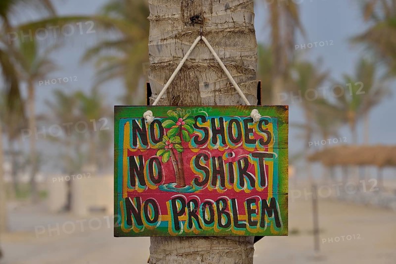 Sign "No shoes, no shirt, no problem" on the beach of Salalah Rotana Resort, Salalah, Dhofar Region, Oman