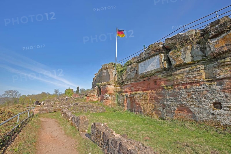 Hohenburg castle ruins with German national flag, red coloured sandstone, rocks, hiking trail, Bliessteig, Schlossberg, Homburg, Saarland, Germany