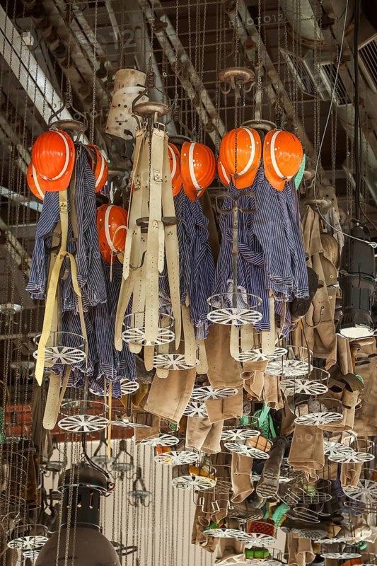Dortmund, North Rhine-Westphalia, Germany - LWL-Industriemuseum Zeche Zollern. Miners' clothing hangs in baskets under the ceiling in the former washing room. The Zollern colliery is a disused coal mine in the north-west of the city of Dortmund, in the Bövinghausen district