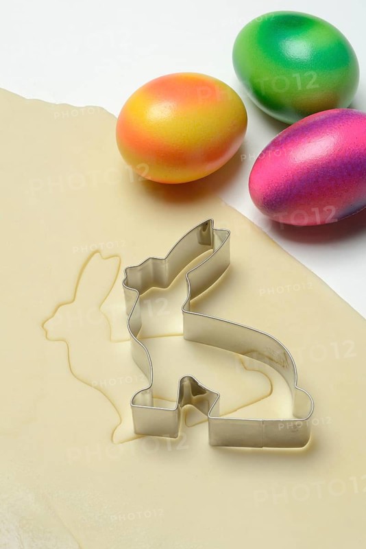 Rolled dough with bunny cookie cutter and easter eggs