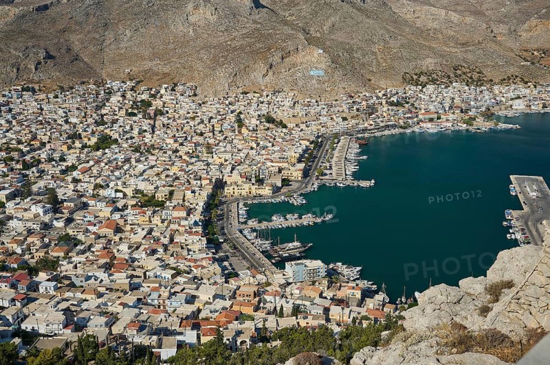 Aerial view of a densely built city on the seashore with mountains, Pothia, main town, port, Kalymnos, Sponge Diving Island, Dodecanese, Greek Islands, Greece