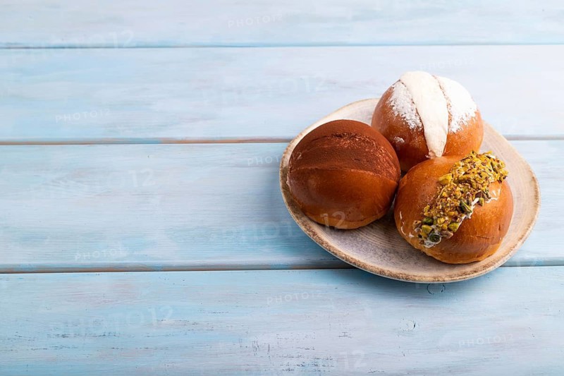 Maritozzo traditional Italian bun dessert on blue wooden background with, copy space, side view