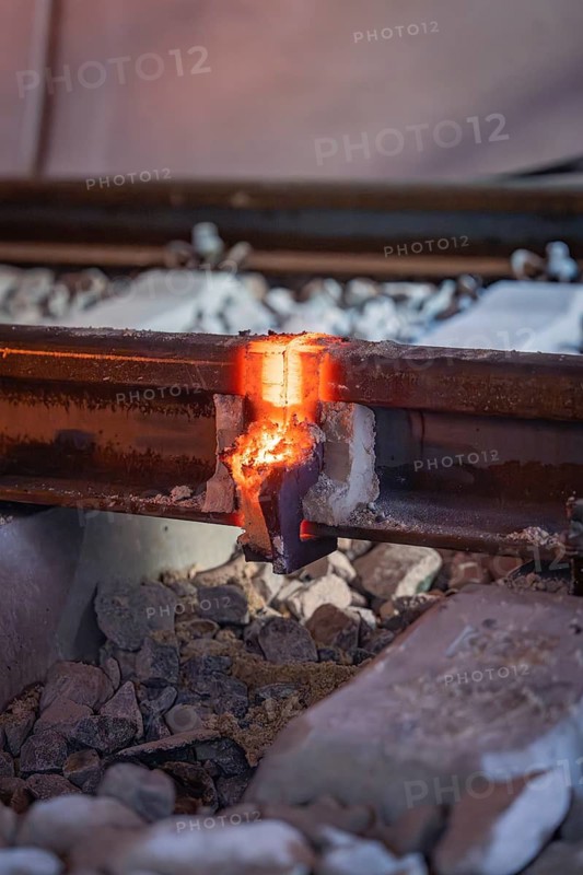 Welding work on a rail interface with molten metal and glowing heat, rail welding, track construction Hermann Hessebahn, Calw, Black Forest, Germany