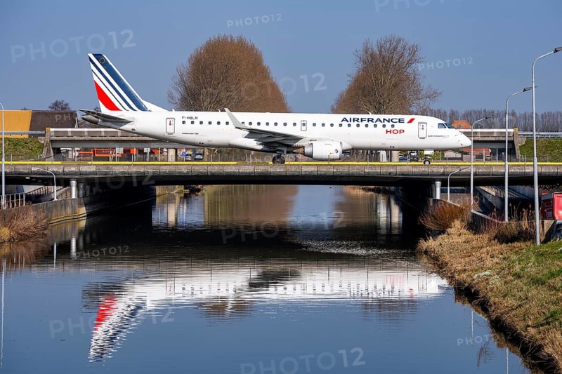 Taxiway bridge over a canal near Hoofddorp, on the Polderbaan, a runway in the west of Amsterdam Schiphol Airport, Air France HOP Embraer 190, aircraft rolls to the terminal after landing, Netherlands