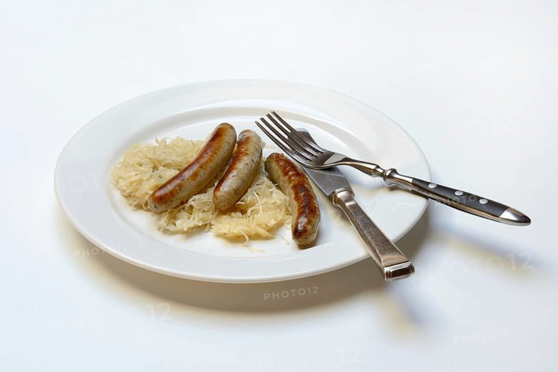 Nuremberg sausages with sauerkraut on a plate, Rostbratwurst, Germany