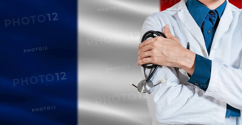 Doctor with stethoscope on France flag. Doctor holding stethoscope on France flag
