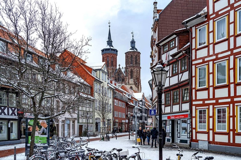Half-timbered houses and St John's Church in Göttingen in winter, Lower Saxony, Germany