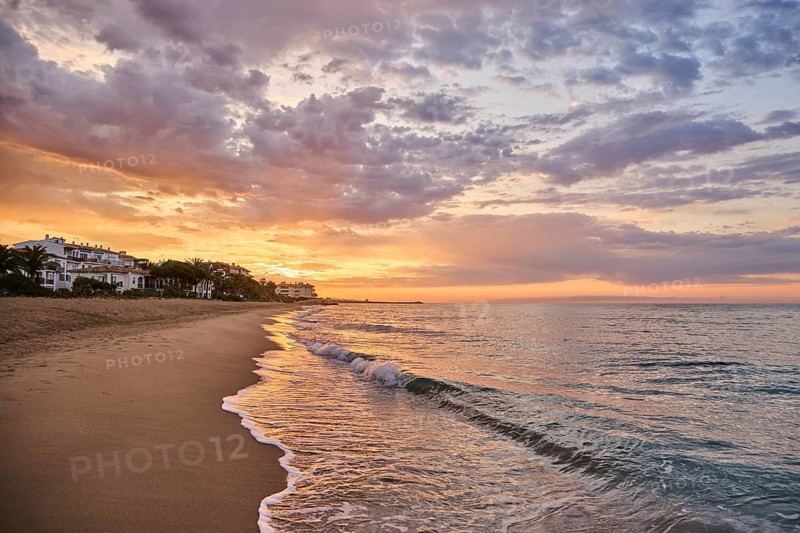 Sunrise with morning colors on a sandy beach near Tarragona, Catalonia, Spain