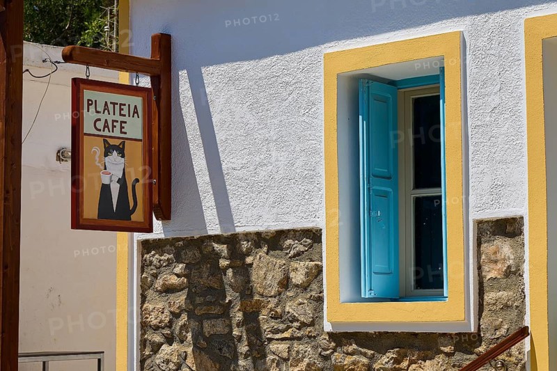 Cosy café with wooden sign and colorful window frames in quiet surroundings, Megalo Chorio, Zero Waste Island, Tilos, Dodecanese, Greek Islands, Greece