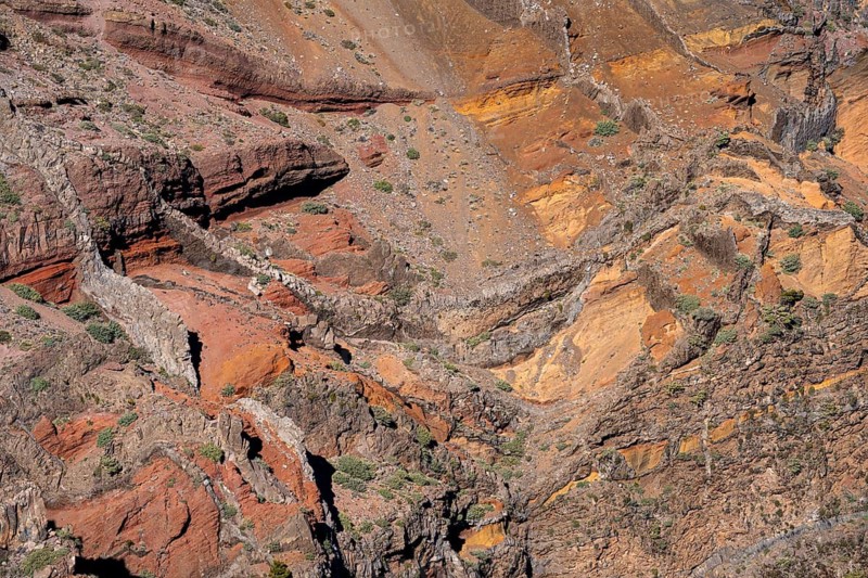 Different rock layers and layers of lava in yellow, orange, ochre and red in the Caldera de Taburiente. View from Roque de los Muchachos. La Palma, Canary Islands, Spain