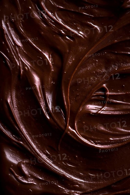 From above background with tempting brown chocolate-flavored paste for spreading on bread