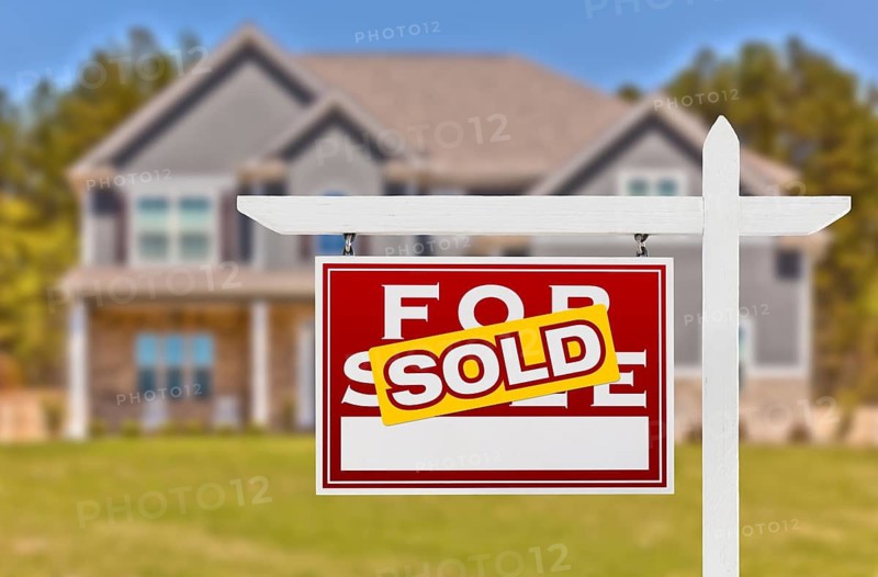 Sold Home For Sale Real Estate Sign in Front of Beautiful New House