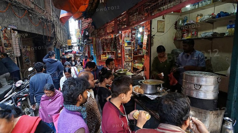 Full street stand with people cooking and eating, busy area, Durbarsquare, Kathmandu, Nepal