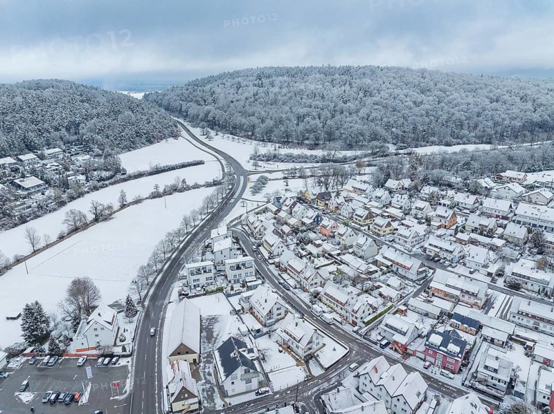 Snow-covered community with roads and winding paths on hills, Aidlingen, Böblingen district, Germany