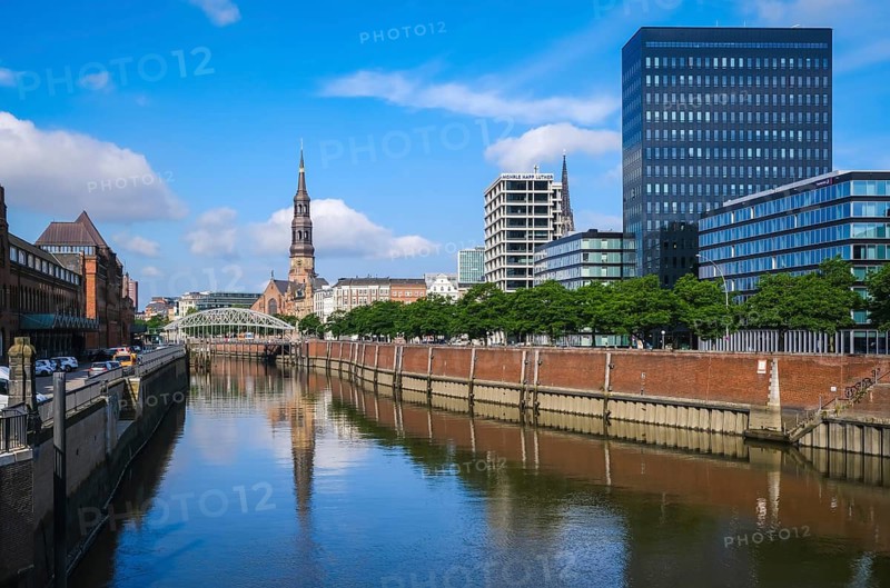 Hamburg, Germany - Speicherstadt, city view at the customs canal in the direction of the old town with the main church St. Katharinen