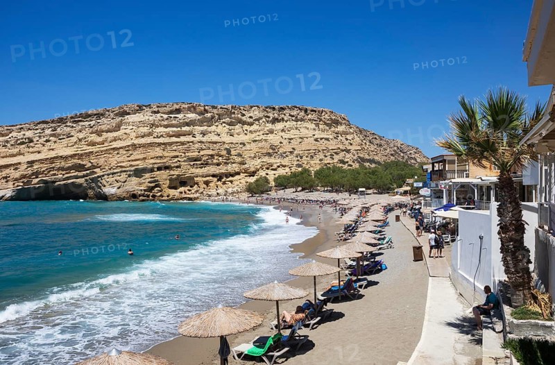Matala beach with a view of the rock caves, south coast, Crete, Greece