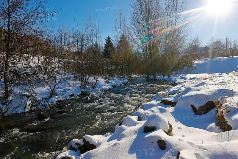 Dortmund, North Rhine-Westphalia, Germany - Sunny winter landscape in the Ruhr area, ice and snow on the renaturalised Emscher, the ecological conversion of the Emscher system consists of the construction of a central wastewater treatment system in the Ruhr area, the construction of underground sewers and the renaturalisation of the Emscher and its tributaries