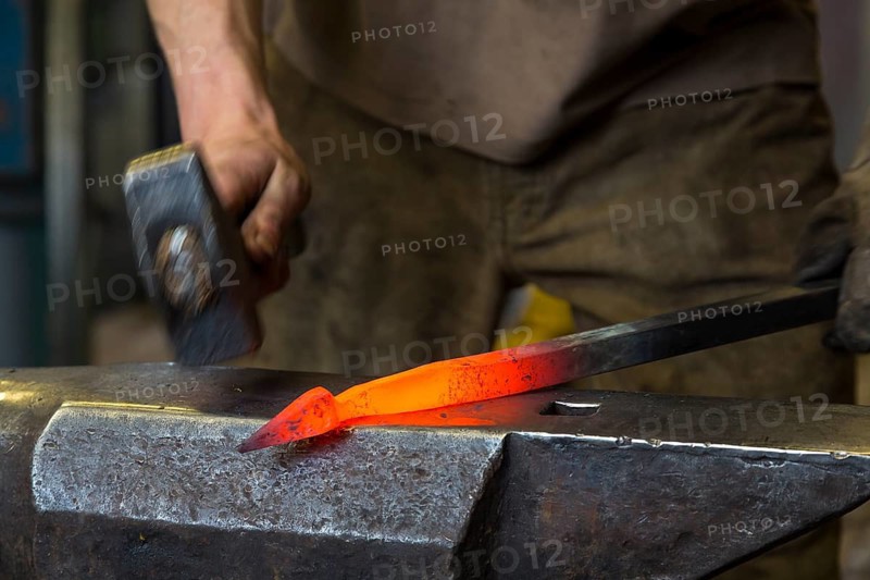 A blacksmith forging, working at the Ehnert forge in Dresden-Bühlau, Saxony, Germany