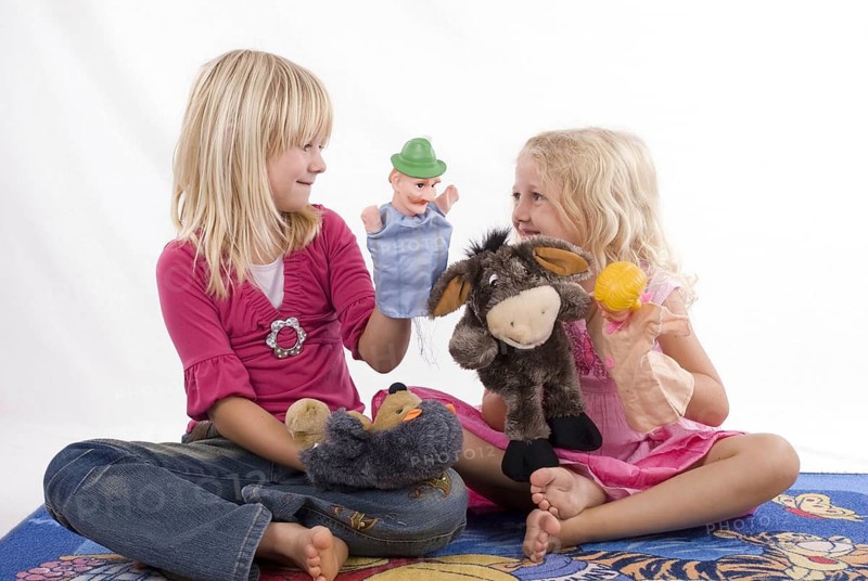 Two blonde girls, 6 and 7 years old, playing with hand puppets, Punch and Judy, figures, theatre, friends, siblings, Punch and Judy show, MR:Yes Studio, Lower Saxony, Federal Republic of Germany