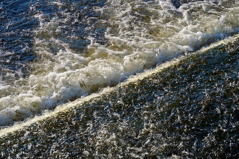 The picture shows the powerful movement of water flowing and splashing over an edge, Windgfällweiher, Lenzkirch, Black Forest, Breisgau Hochschwarzwald, Baden-Württemberg, Germany