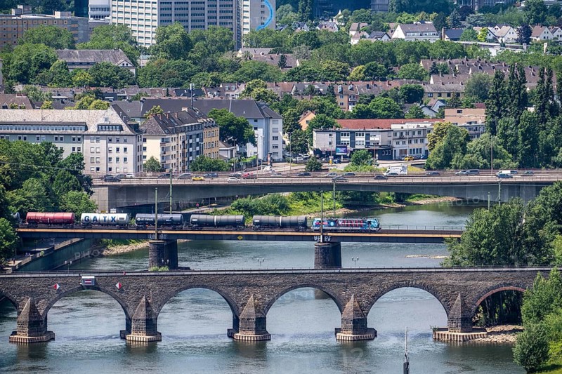 The bridges across the Moselle just in front of it flows into the Rhine, road and railway bridges, freight train, Koblenz, Rhineland-Palatinate, Germany