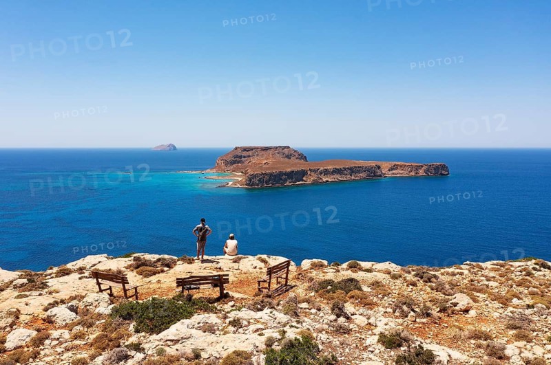 Hikers on the way to the cape of the Gramvousa peninsula with a view of the island of Imeri Gramvousa, Kolimbari, West Crete, Crete, Greece
