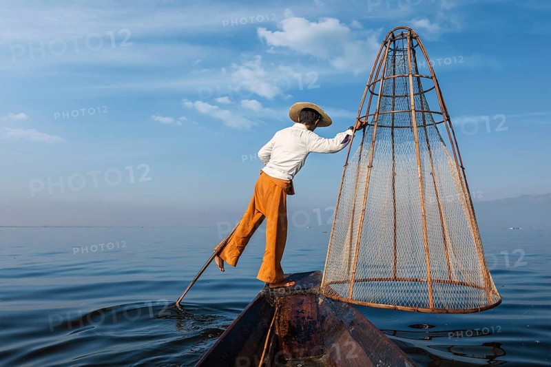 Myanmar travel attraction landmark, Traditional Burmese fisherman with fishing net at Inle lake in Myanmar famous for their distinctive one legged rowing style, view from boat