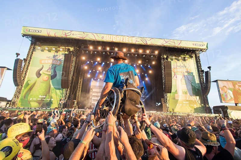 A wheelchair user is carried across the audience during the performance of the band Feine Sahne Fischfilet at the Highfield Festival on Saturday, Störmthaler See, 17/08/2024