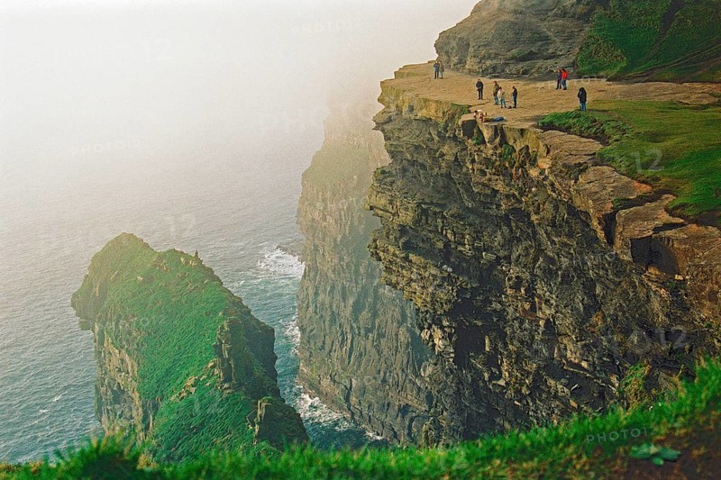 People on the edge of a cliff, there was no fence back then, Cliffs of Moher, County Clare, Republic of Ireland, April 9, 1995, vintage, retro, old, historic