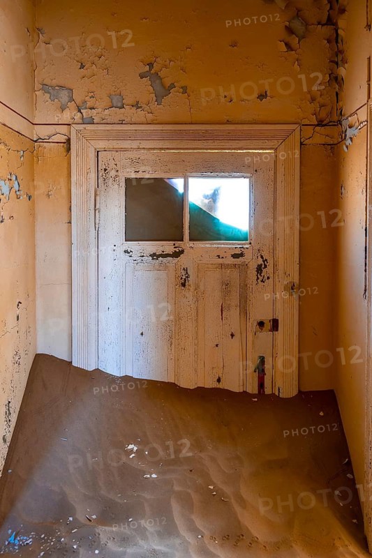 Interior view, door and house full of sand, former diamond mining town, Namib Desert, Kolmanskop, Karas, Namibia