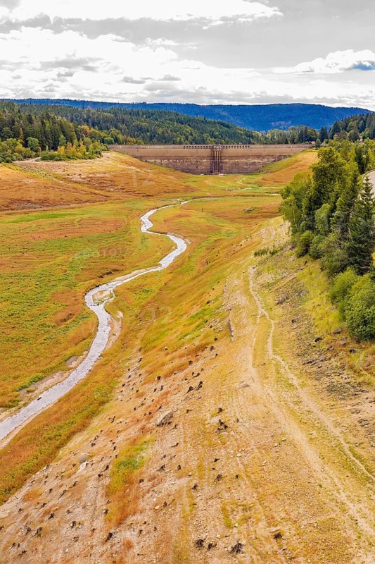 A narrow river runs through the valley with a dam and meadows, rehabilitation of the Schwarzenbach dam, Forbach, Black Forest, Germany