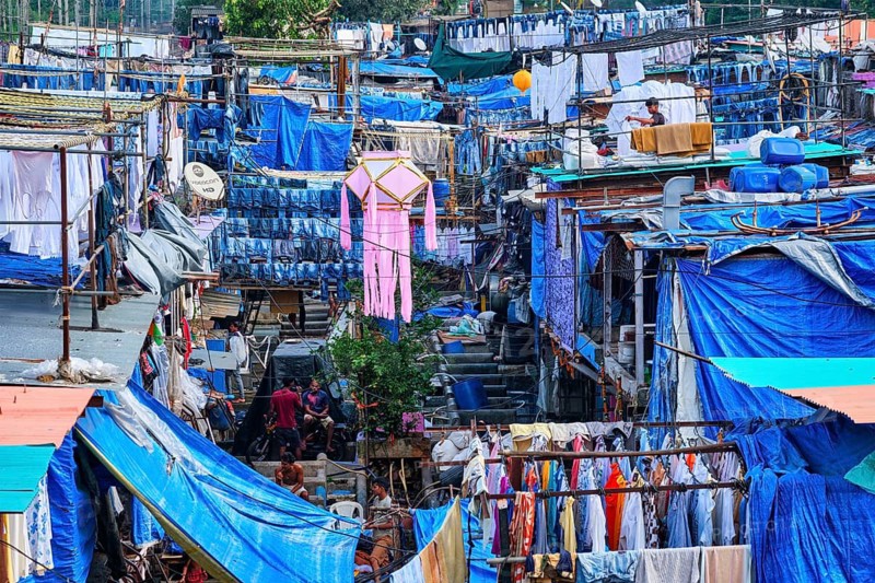 MUMBAI, INDIA, OCTOBER 31, 2019: Dhobi Ghat (Mahalaxmi Dhobi Ghat) is open air laundromat lavoir in Mumbai, India with laundry drying on ropes. Now signature landmark tourist attractions of Mumbai