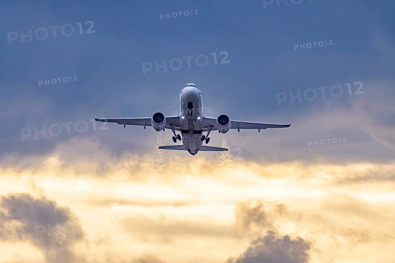 Stuttgart airport with plane taking off. Eurowings Airbus A320 in front of dark clouds, lighting in the evening. Stuttgart, Baden-Württemberg, Germany