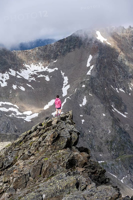 Hiker on a rock, Lasörling Höhenweg, Lasörling Group, Hohe Tauern National Park, East Tyrol, Tyrol, Austria