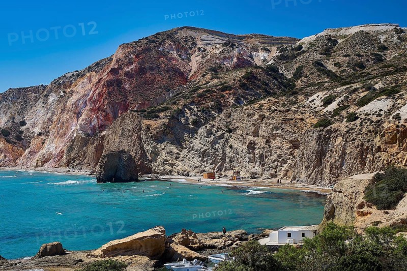 Beach, volcanic rock, panoramic view of a coastal bay with rocks, residential buildings and blue water, Trypiti, Tripiti, village, Milos, island, Cyclades, Greek Islands, Greece