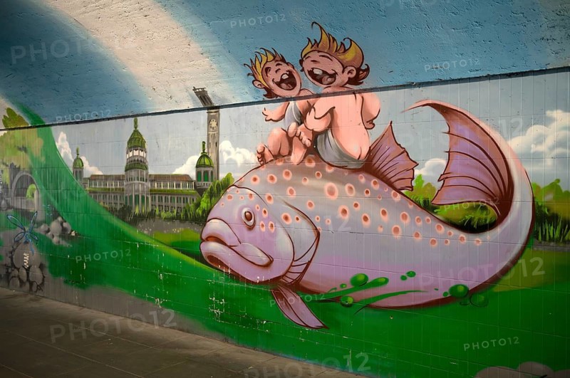 Münchener Kindl on fish, graffiti by Miriam Frank and street art artists Loomit and Flin, underpass for pedestrians and cyclists under Ludwigsbrücke, Muffathalle, Muffatwerk, Munich, Bavaria, Germany