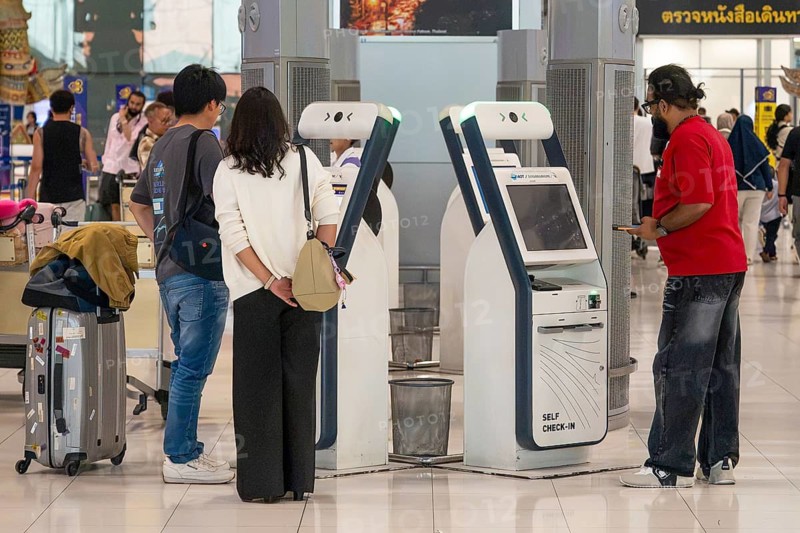 Passengers at self-check-in machine, Bangkok, Thailand