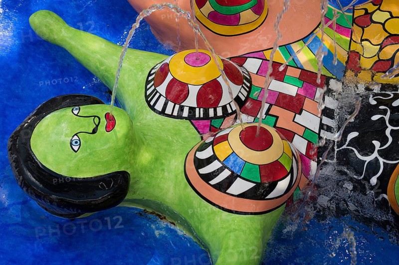 Woman lying down, Nana figure, colorful sculpture in a fountain, Giardino dei Tarocchi or Garden of Tarot, by Niki de Saint Phalle and Jean Tinguely, near Capalbio, Grosseto Province, Tuscany, Italy