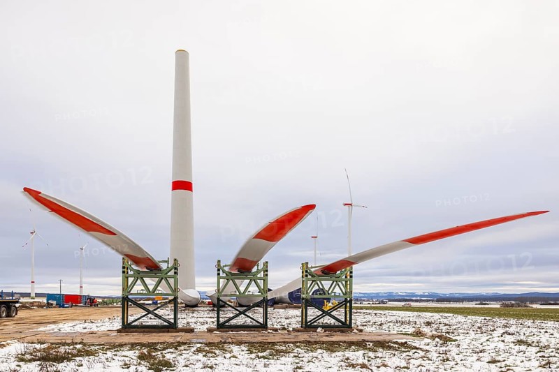 Rotor blades lying in front of the unfinished tower at the Cramme wind farm construction site, Oderwald, Lower Saxony, Germany