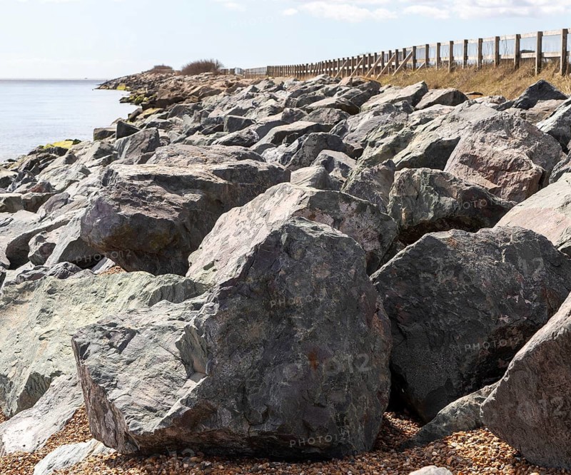 Rock armour coastal defences against erosion, East Lane, Bawdsey, Suffolk, England, UK