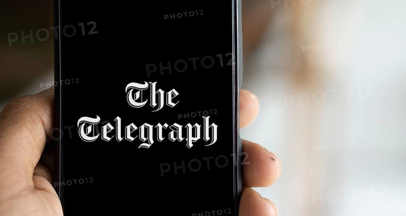 the telegraph logo is displayed on smartphone. The Telegraph is a British daily broadsheet newspaper published company