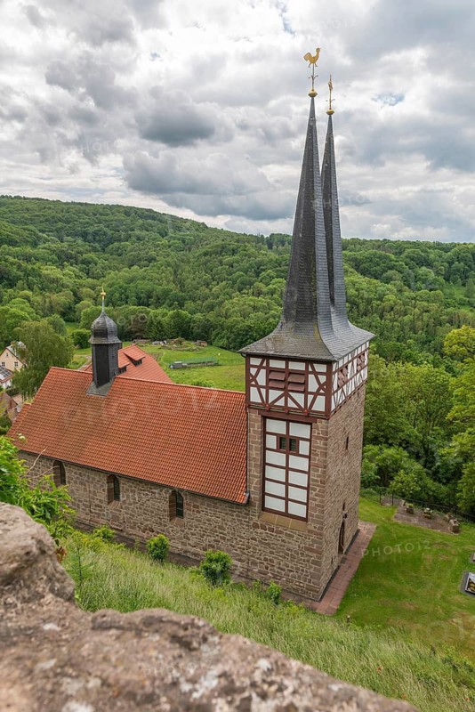 View from the Hanstein castle ruins to the Catholic St Mary's Church in Rimbach, Bornhagen, double tower, ridge turret, half-timbered, wooded low mountain range landscape, Eichsfeld district, Thuringia, Germany