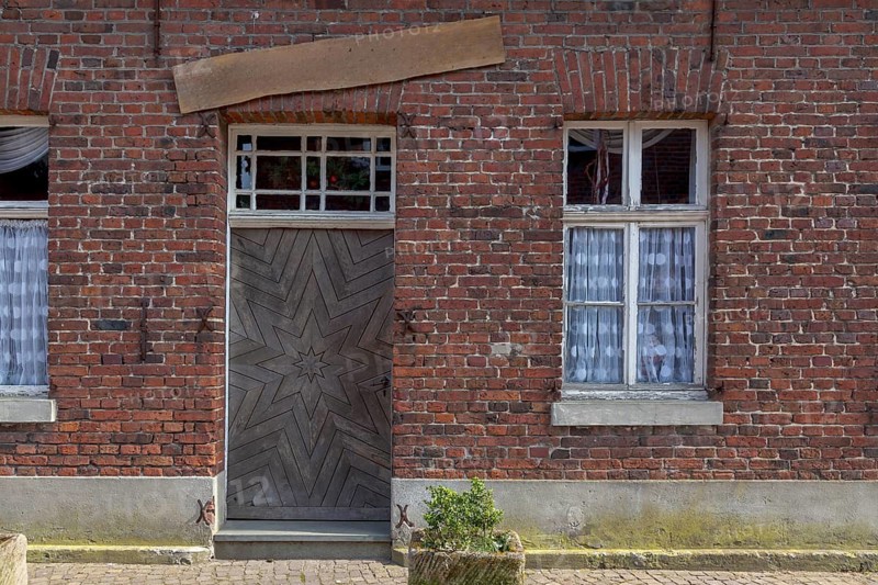 Red brick house façade with front door and window, Historische Freiheit Raesfeld, Münsterland, North Rhine-Westphalia, Germany