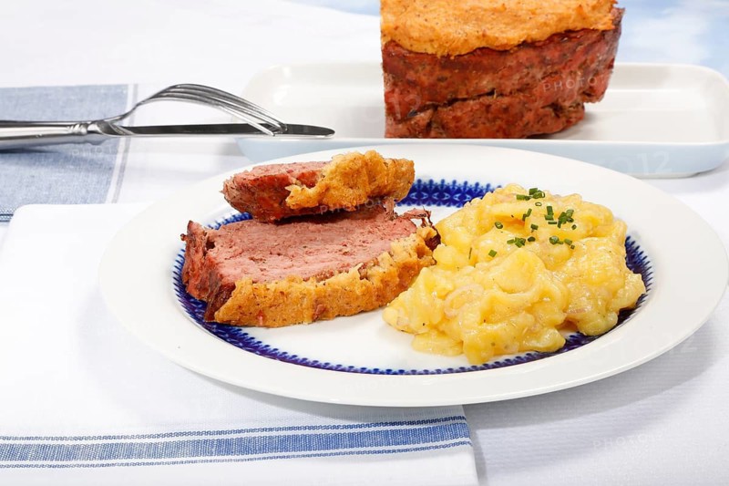 Swabian cuisine, Stuttgarter Leberkäs in a horseradish-mustard coating, Swabian potato salad, Leberkäse, meat loaf, mustard crust, grandmother's cooking, regional, home cooking, typical Swabian, traditional cuisine, serving platter, cutlery, plate, food photography, studio, Germany
