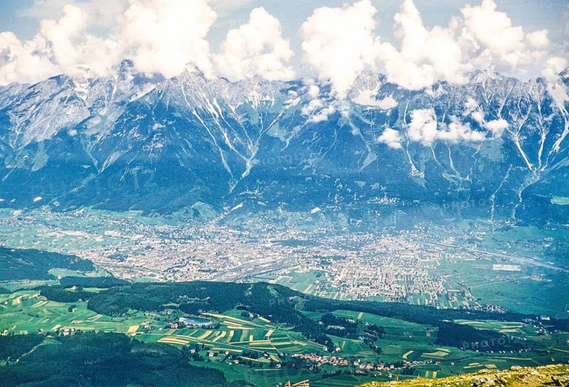 Elevated oblique view of the glaciated mountains of the Inn Valley rising above the city of Innsbruck, Austria, Europe 1950, looking north