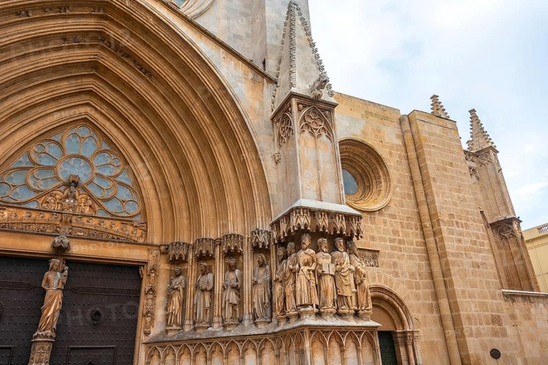 Stone sculptures decorating the main entrance of the tarragona cathedral in catalonia, spain, showcasing the intricate details of gothic architecture