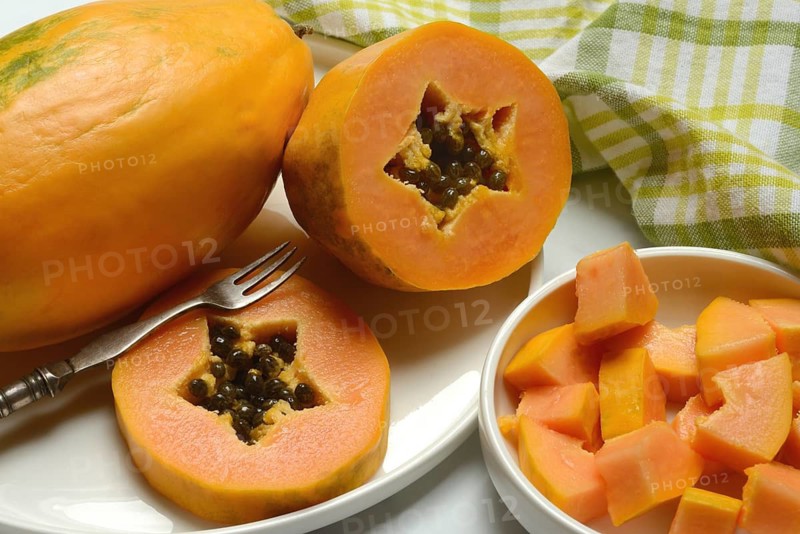 Pawpaw, split fruit in skin, halved and whole fruit, Carica papaya