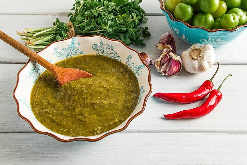 Tkemali sauce, traditional Georgian cuisine, green cherry plum, with ingredients for sauce, cilantro, mint, hot pepper, garlic, on a white wooden table, close-up, rustic, food background, no people, selective focus, sauce, green sauce, tkemali, georgian cuisine, homemade