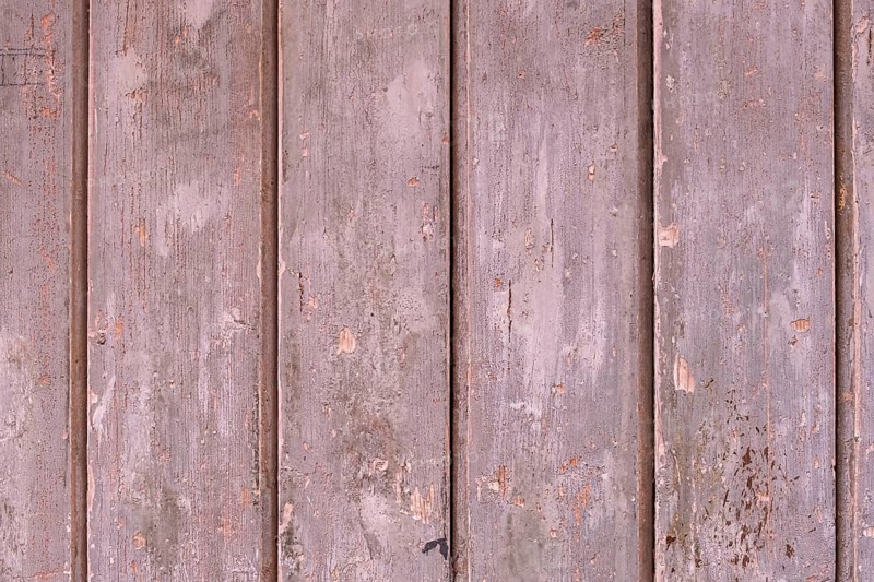 Old wooden door with peeling paint, texture, background, Apulia, Italy