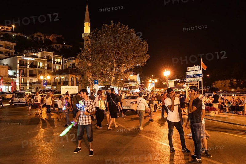 ULCINJ, MONTENEGRO - JUNE 22, 2019: Nightlife ine the city with crowd of people during summer evening.